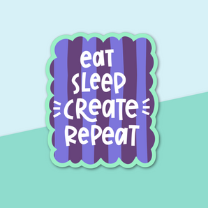 Hand lettered sticker with "Eat Sleep Create Repeat" written on it