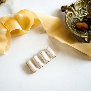 ceramic paintbrush rest with gold details