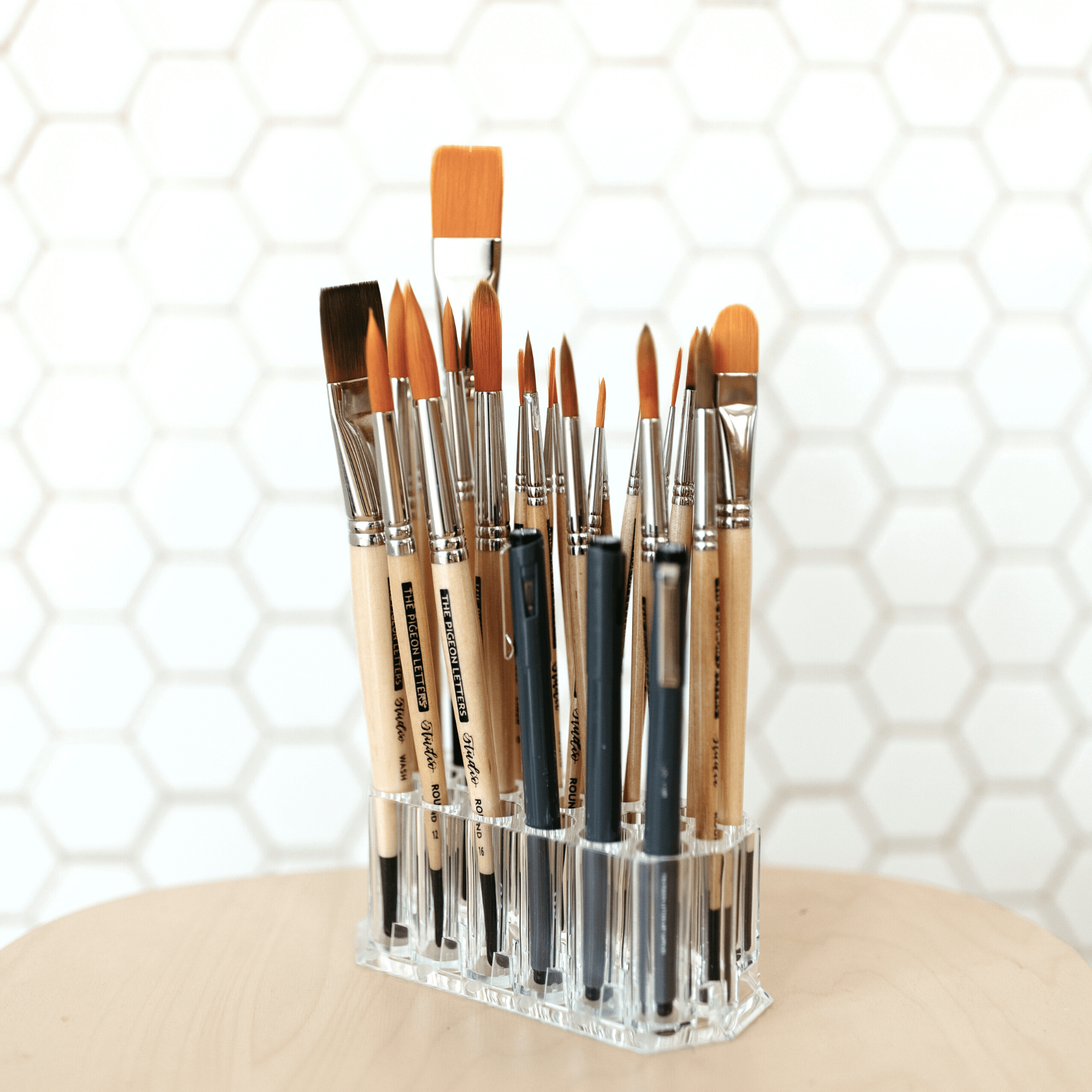 Collection of cruelty-free art supplies including brushes and pens